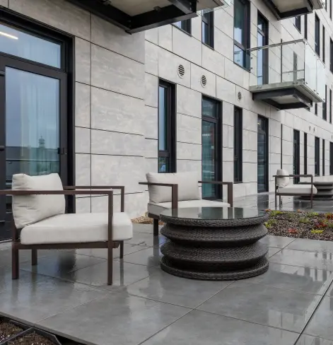 Outdoor patio seating area at Burlington Square featuring modern lounge chairs and contemporary architecture